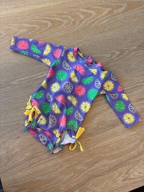 RuffleButts Purple Lemon Lime Rash Guard Swimsuit | 6-12 Months